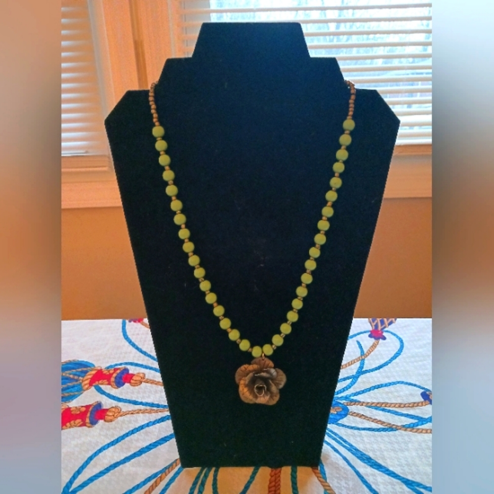 Green and silver beaded necklace with flower pendent